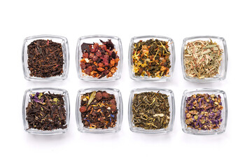 An assortment of various dry tea leaves, showcasing different textures, colors, and blends