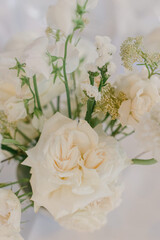 Elegant bouquet of white flowers arranged for a special event in a soft, romantic setting