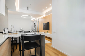 Modern kitchen and living area with minimalist design in a bright apartment setting