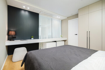 Modern bedroom design featuring minimalist decor and stylish furniture in a contemporary apartment setting