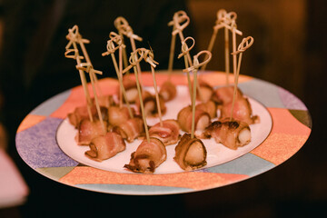 Savory appetizers served on a colorful plate during evening gathering in a cozy setting