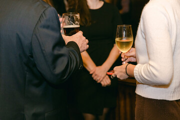 Elegant evening gathering of friends enjoying drinks with a warm atmosphere in a sophisticated setting