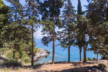 Historic Vido island coastline, known as Blue Tomb where Serbian soldiers were buried at sea during World War I, featuring pristine turquoise waters and memorial significance in Greek waters.