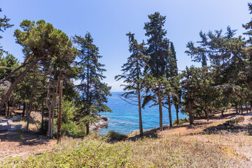 Historic Vido island coastline, known as Blue Tomb where Serbian soldiers were buried at sea during World War I, featuring pristine turquoise waters and memorial significance in Greek waters.