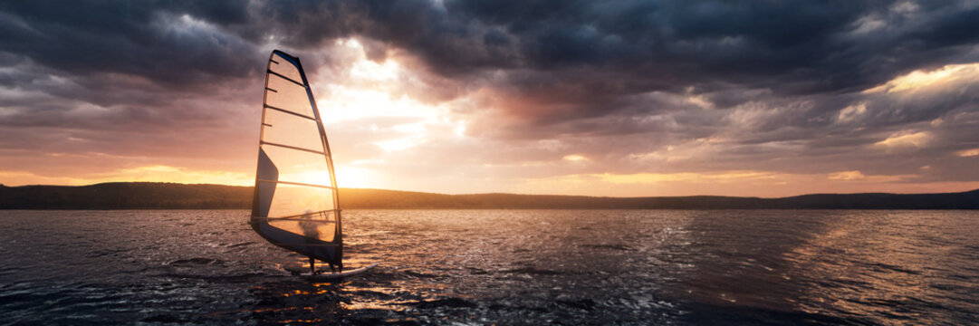 Windsurfing at Sunset Over Serene Lake Wide Banner - Powered by Adobe