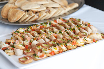 A beautifully arranged platter boasts an array of gourmet tapas, blending flavors and colors that tantalize the senses at a lively food festival. Fresh ingredients highlight each bite.