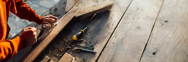 Carpenter Working on Woodwide Banner with Copy Space