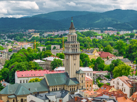 Aerial view of historic town square in Bielsko-Biała, Poland with colorful buildings and mountains in the background. - Powered by Adobe