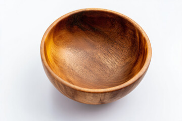 a wooden bowl on a white surface