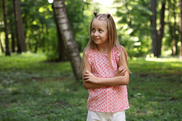 Fototapeta premium Cute little girl in park, space for text