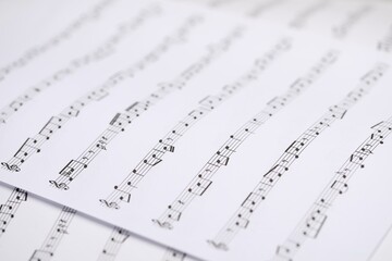Sheets with musical notes as background, closeup