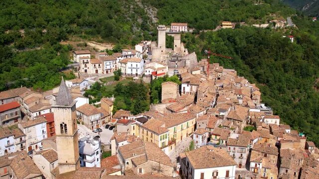 Pacentro Abruzzo Italy 4K Aerial. Drone close flyby over rooftops towards medieval castle towers. Scenic Italian mountain borgo L' Aquila province travel Hidden gems