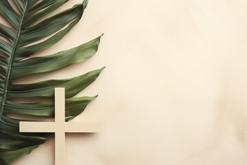 Simple arrangement of wooden cross and palm leaf on beige background provides serene backdrop for faith based message