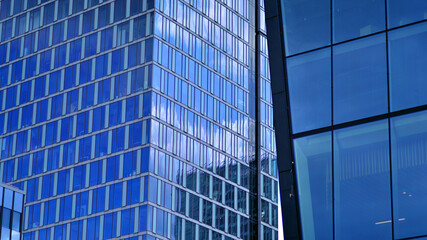 Fototapeta premium Modern sustainable glass office buildings. Exterior view of corporate headquarters glass buildings architecture.Glass windows in energy-efficient buildings. Financial business center buildings. 