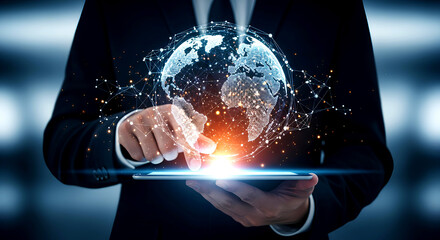 Global business and technology concept. Businessman using a tablet with a futuristic hologram of the Earth's global network, representing big data, internet connection, and digital transformation.