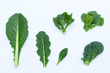 a group of green vegetables on a white surface