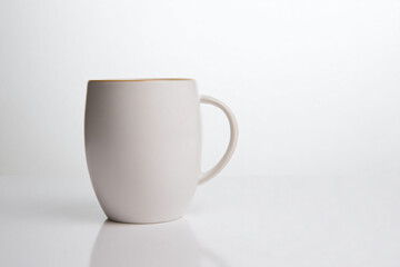 Obraz premium a white coffee cup sitting on a table