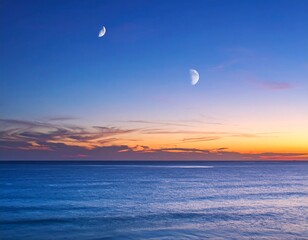 Two crescent moons over a tranquil sunset ocean