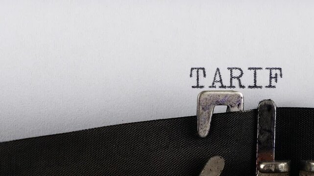 The phrase TARIFF POLICY is typing on a retro typewriter.