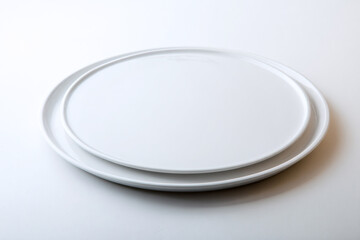 a white plate with a white rim on a white table