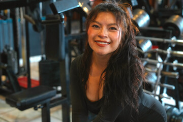 Fototapeta premium Happy fitness woman smiling and posing in gym