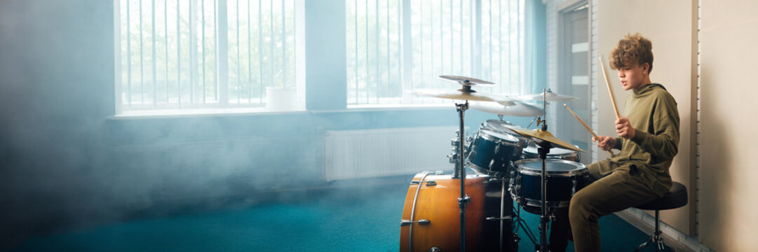 Teen Drummer Practicing in Wide Banner with Copy Space