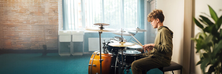 Teen Drummer in Studio Wide Banner with Copy Space
