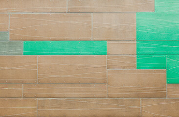 The building's facade is covered with decorative tiles on rivets.