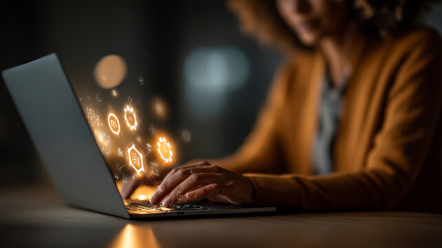 Woman working on laptop with glowing data interface