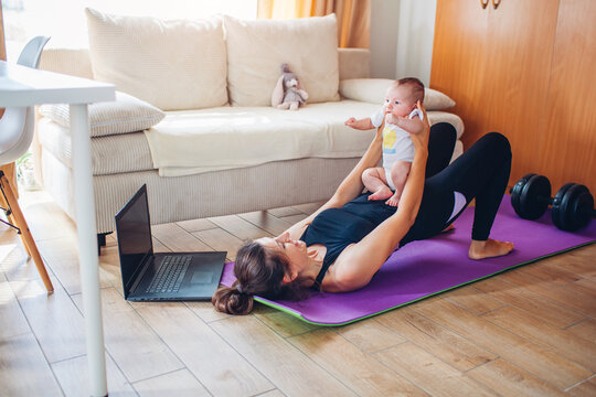 Postpartum recovery workout at home. Young woman doing pelvic floor exercises together with baby girl on yoga mat. - Powered by Adobe