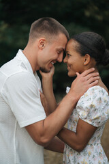 Fototapeta premium Affectionate moment of an interracial couple, close-up portrait of love, joy and authentic emotions.