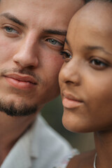 Affectionate moment of an interracial couple, close-up portrait of love, joy and authentic emotions.