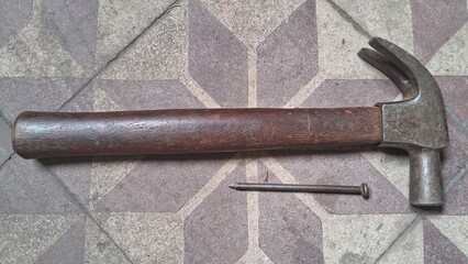 Hammer and Nail on a tile floor