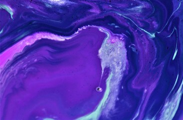 Abstract background of acrylic paint in blue and purple tones. Close-up