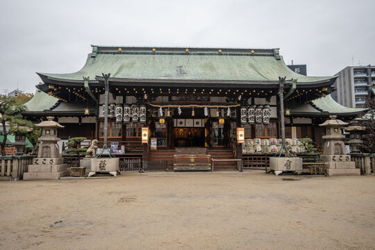 Tenmangu Shrine in Osaka, Japan - A serene shrine, showcasing traditional architecture. Green roof, lanterns, and sake barrels adorn this peaceful temple.