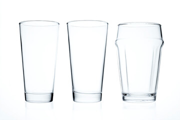 three glasses are lined up on a white surface