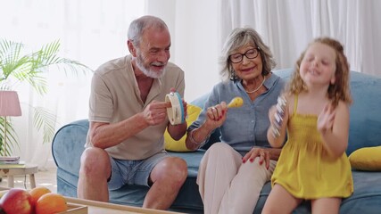 Grandparents playing music with granddaughter in slow motion - Powered by Adobe
