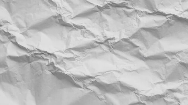 Crumpled White Paper Texture Background - Close-up view of a crumpled white paper texture. The video shows the detailed wrinkles and creases of the paper, creating a dynamic and textured background.