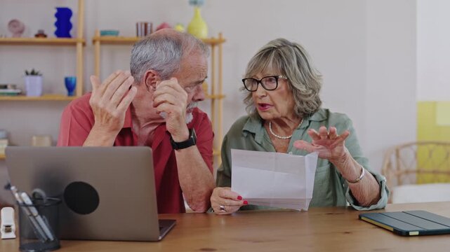 Senior couple reacting to bad news on a letter in slow motion - Powered by Adobe
