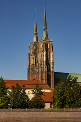 Naklejka premium Majestic gothic cathedral with twin spires under clear blue sky, symbol of Catholic faith, education, enlightenment and spiritual heritage. Religion, history, culture and Christian values