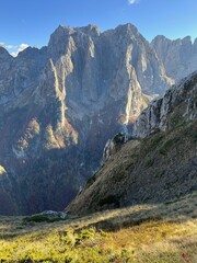Mountain range of Prokletije National Park, Montenegro. Golden autumn in the mountains on a sunny day. Hike to Volushnica mountain.