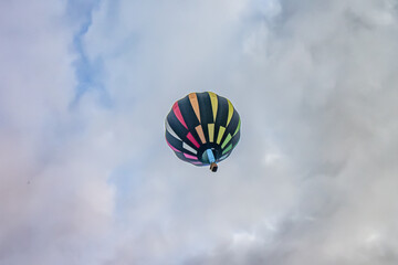 Black, Red, Orange and yellow hot air balloon in the sky