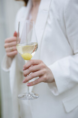 Elegant relaxation with a refreshing cocktail at a chic outdoor gathering in the afternoon sun