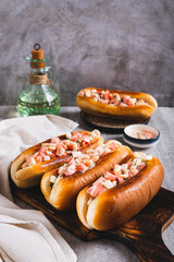 Delicious hot dogs in fried buns with tomato, egg and shrimp salad vertical view