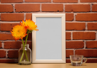 blank frame mockup with flowers on wooden table