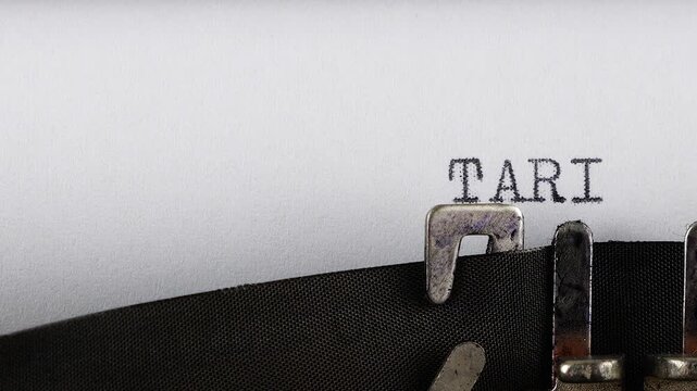 The phrase TARIFF REFORM is typing on a retro typewriter.