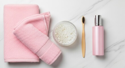 Naklejka premium Pink bath accessories including a folded towel, a jar of bath pearls, a bamboo toothbrush, and a pink bottle