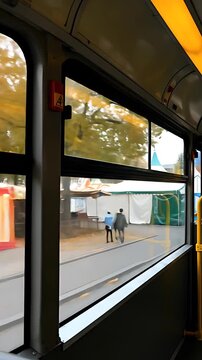 Oktoberfest decorations adorn a city bus window, blurred motion capturing festive German culture passing by during the autumn celebration.