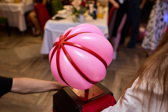 A colorful Balloon Hat adds fun and creativity to a lively community event celebration