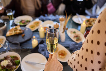 Elegant Hand Holding a Glass of Ros Champagne at an Event